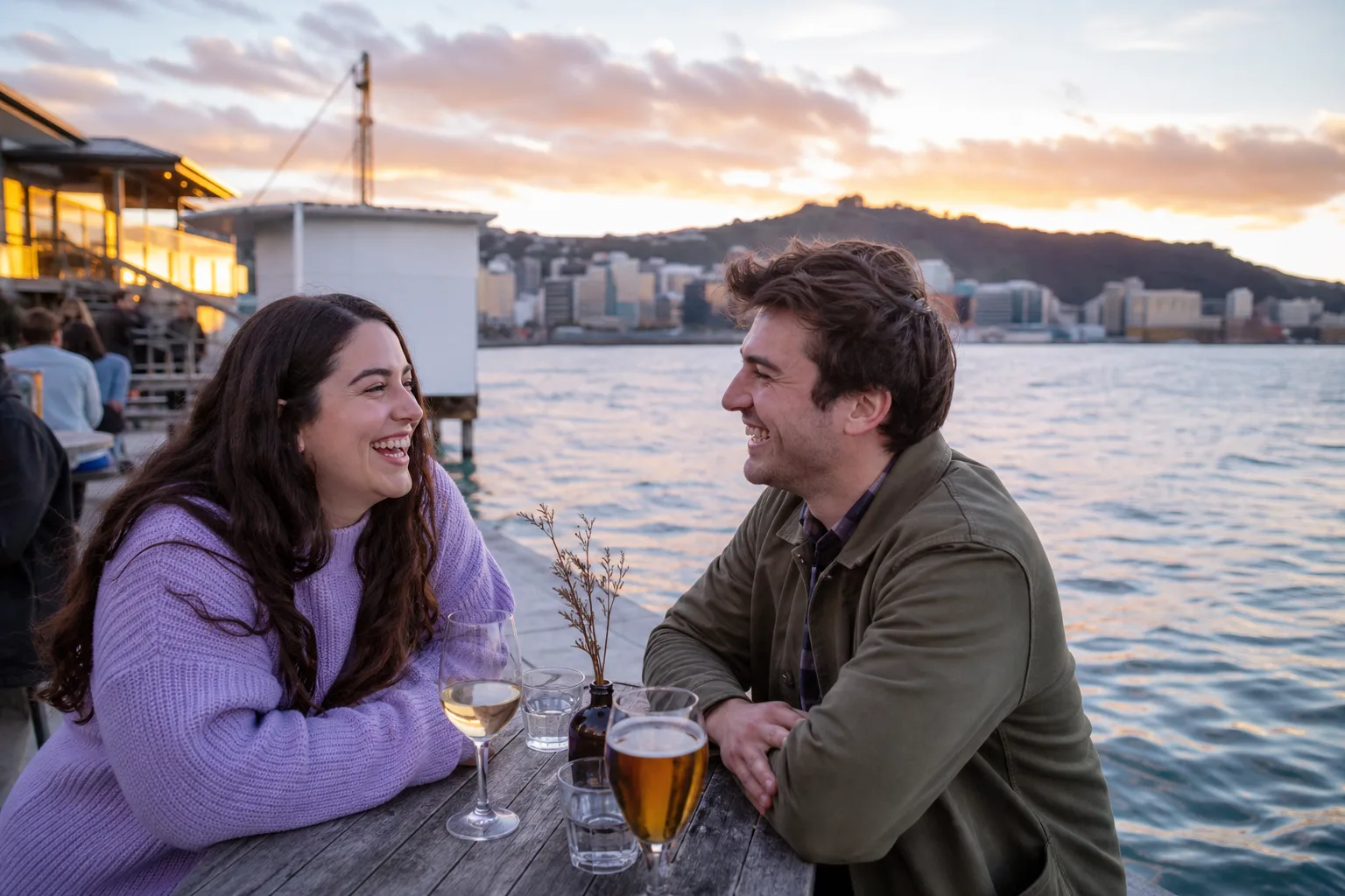 Two people talking over coffee beside the Wellington waterfront