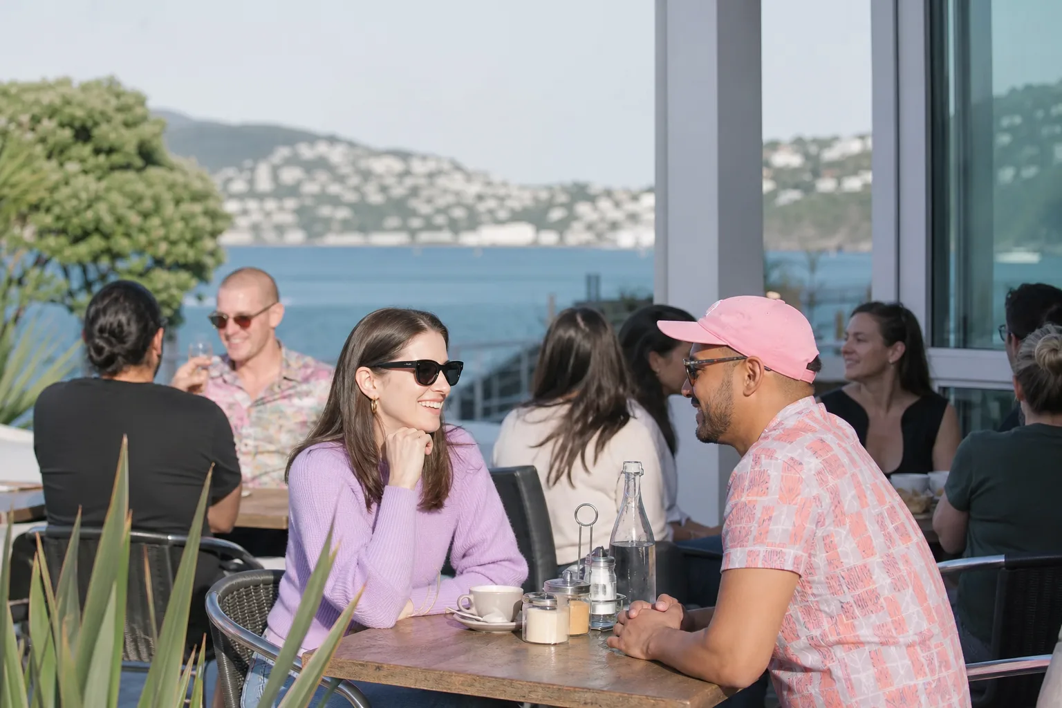 Two people talking over coffee beside Wellington waterfront