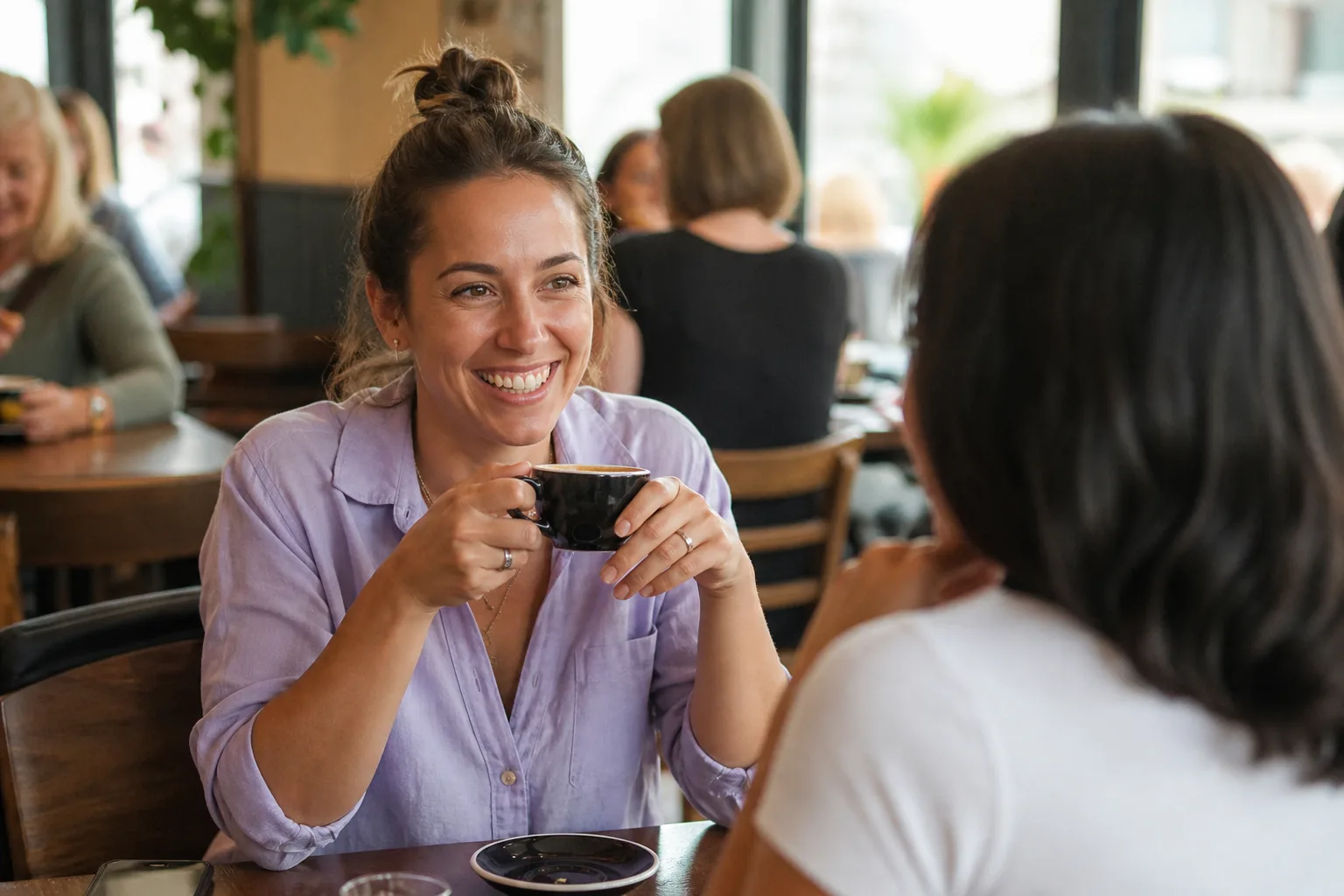 Two people talking over coffee on Wellington waterfront
